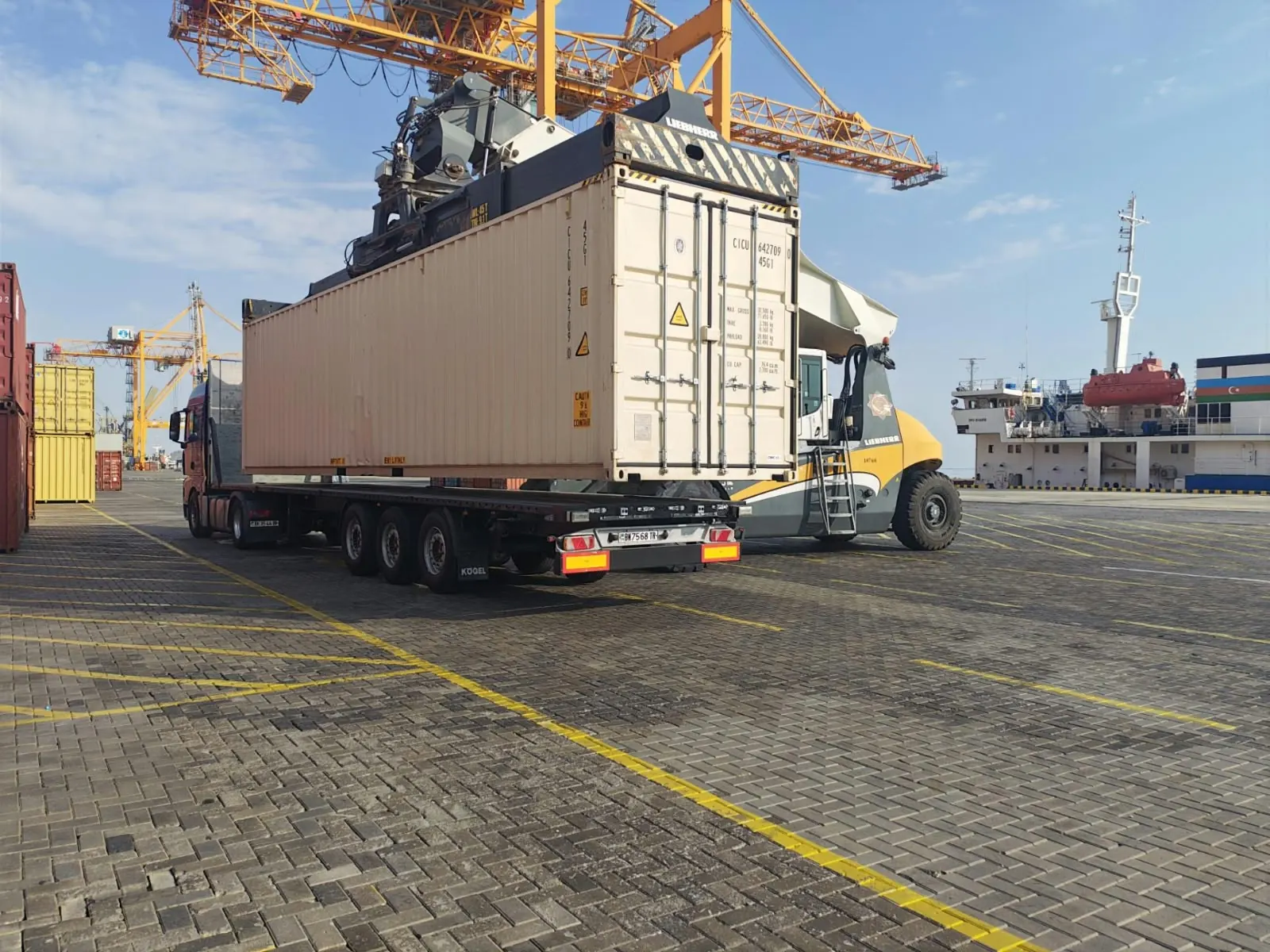 Reach stacker loading a container at the port